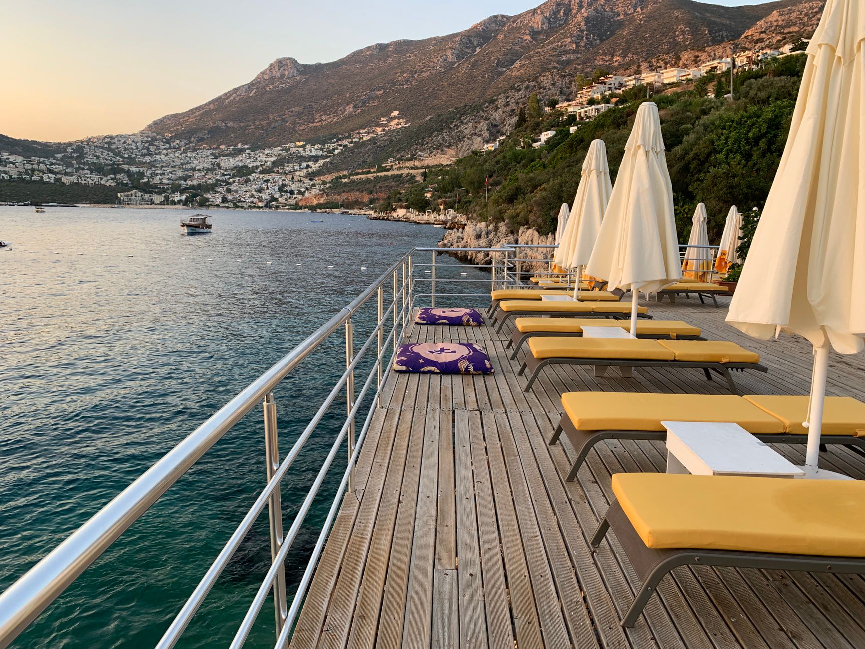 Timber sun deck with loungers looking out to sea